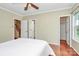 Bedroom features a ceiling fan, hardwood floors, and stairway access at 4263 Melrose Club Dr, Matthews, NC 28105