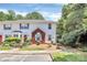Charming two-story townhome featuring white siding, a brick facade, and a well-manicured front yard with lush landscaping at 4263 Melrose Club Dr, Matthews, NC 28105