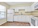 Well-lit kitchen showcasing white cabinets, tiled floors, and modern appliances at 4263 Melrose Club Dr, Matthews, NC 28105