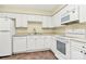 Efficient kitchen with white cabinets, tiled floors, and modern appliances at 4263 Melrose Club Dr, Matthews, NC 28105