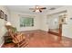 Bright, open living room featuring hardwood floors, large windows, and a classic rocking chair, creating a cozy atmosphere at 4263 Melrose Club Dr, Matthews, NC 28105
