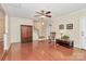 Spacious living room with hardwood floors, a wooden entertainment center, and a cozy rocking chair creating a relaxed ambiance at 4263 Melrose Club Dr, Matthews, NC 28105