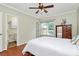 Bedroom featuring hardwood floors, ceiling fan, and ensuite bathroom at 4263 Melrose Club Dr, Matthews, NC 28105