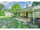Large covered back porch with brick chimney perfect for outdoor entertaining and relaxation at 4612 Rehobeth Rd, Waxhaw, NC 28173