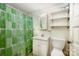 Small bathroom with a white sink, toilet, and a shower curtain featuring a green leaf pattern at 4612 Rehobeth Rd, Waxhaw, NC 28173