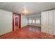 Rustic bedroom featuring red wood floors, whitewashed walls, and natural light from the windows at 4612 Rehobeth Rd, Waxhaw, NC 28173