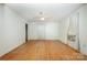 Spacious bedroom with hardwood floors, a ceiling fan, large window, and a built-in air conditioning unit at 4612 Rehobeth Rd, Waxhaw, NC 28173