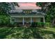 Charming single-story home featuring a covered front porch with white pillars, surrounded by mature trees and a lush green lawn at 4612 Rehobeth Rd, Waxhaw, NC 28173