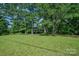 Well-manicured front yard with mature trees, offering a serene and inviting curb appeal at 4612 Rehobeth Rd, Waxhaw, NC 28173