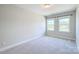 Bright, carpeted bedroom with two windows and neutral paint at 4714 Blanchard Way, Charlotte, NC 28226