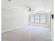 Bright and airy bedroom with plush carpeting, ceiling fan, and large window at 4714 Blanchard Way, Charlotte, NC 28226