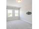 Bright, carpeted bedroom with two windows and a pre-mounted TV mount at 4714 Blanchard Way, Charlotte, NC 28226