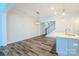 Open concept dining area with wood floors and modern lighting fixtures, adjacent to kitchen at 4714 Blanchard Way, Charlotte, NC 28226