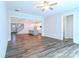Open living space with hardwood floors, ceiling fan, and view into the modern kitchen at 4714 Blanchard Way, Charlotte, NC 28226