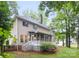 Backyard view with screened porch, deck, stairs, and lush greenery at 4808 Cobble Glen Way, Charlotte, NC 28269