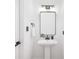 Powder room featuring white walls, black fixtures, and a pedestal sink at 4808 Cobble Glen Way, Charlotte, NC 28269