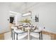 Dining room with seating for four, modern lighting, and a view into the living room at 4808 Cobble Glen Way, Charlotte, NC 28269