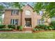 Charming brick two-story home featuring a landscaped front yard, black shutters, and classic architectural details at 4808 Cobble Glen Way, Charlotte, NC 28269