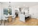 Bright kitchen boasts a waterfall island, stainless appliances, and adjacent breakfast nook at 4808 Cobble Glen Way, Charlotte, NC 28269