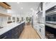Open-concept kitchen with a contrasting navy blue island and modern fixtures at 4808 Cobble Glen Way, Charlotte, NC 28269