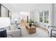 Open concept living room with white walls, hardwood floors, and dining area beyond at 4808 Cobble Glen Way, Charlotte, NC 28269