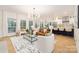 Open concept living room with a chandelier, white walls, and modern furniture at 4808 Cobble Glen Way, Charlotte, NC 28269