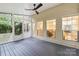 Cozy screened porch featuring a ceiling fan and glimpses into the inviting interior through bright windows at 4808 Cobble Glen Way, Charlotte, NC 28269