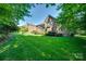 Expansive backyard with healthy grass and mature trees surrounding the house at 5008 Woodview Ln, Weddington, NC 28104