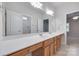 Bathroom showcasing double sinks, a spacious countertop, and a shower behind a glass door at 5008 Woodview Ln, Weddington, NC 28104