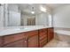 Bathroom with double sink vanity, large mirror, soaking tub, and shower at 5008 Woodview Ln, Weddington, NC 28104
