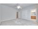 Bright bedroom features neutral paint and carpet with a doorway to another room and double closet at 5008 Woodview Ln, Weddington, NC 28104
