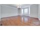 Formal dining room with hardwood floors, wainscoting, and a bay window offering ample natural light at 5008 Woodview Ln, Weddington, NC 28104