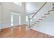 Bright, open foyer with hardwood floors, staircase, and large windows creating a grand entrance at 5008 Woodview Ln, Weddington, NC 28104