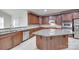 This beautiful kitchen features a large center island, stainless appliances and stone countertops at 5008 Woodview Ln, Weddington, NC 28104