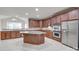 Large island with granite countertops provides additional seating and workspace in this well-equipped kitchen at 5008 Woodview Ln, Weddington, NC 28104