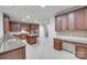 Spacious kitchen features stainless steel appliances, granite countertops, tile backsplash, and large center island at 5008 Woodview Ln, Weddington, NC 28104