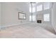 Bright living room with a fireplace, large windows, and a decorative mirror above the mantel at 5008 Woodview Ln, Weddington, NC 28104