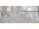 Well-lit loft space with hardwood railing overlooking the staircase at 5008 Woodview Ln, Weddington, NC 28104
