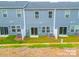 Townhouse exterior showing a small, grassy backyard area with privacy fencing and a sliding glass door entrance at 508 Tayberry Ln, Fort Mill, SC 29715