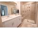 Bathroom featuring double vanity, a glass shower with a built-in seat, and tile flooring at 508 Tayberry Ln, Fort Mill, SC 29715