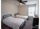 Bedroom with two twin beds, ceiling fan, neutral carpet, and a dresser by the window at 508 Tayberry Ln, Fort Mill, SC 29715