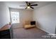 A carpeted bedroom with a crib, ceiling fan, window with blinds, and a dresser at 508 Tayberry Ln, Fort Mill, SC 29715