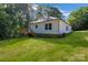 A well-maintained backyard features a wooden deck and mature trees, offering a private outdoor space at 5175 Grand Canyon Rd, Concord, NC 28027