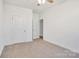 Bedroom featuring neutral carpet, two doors and a ceiling fan at 5175 Grand Canyon Rd, Concord, NC 28027