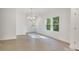 Bright dining area with modern light fixture, neutral walls, and lots of natural light at 5175 Grand Canyon Rd, Concord, NC 28027