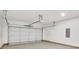 A two car garage with a white door, concrete floor, and an automatic opener at 5175 Grand Canyon Rd, Concord, NC 28027