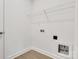 A laundry room featuring vinyl flooring and a wire shelf above hookups at 5175 Grand Canyon Rd, Concord, NC 28027