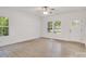 Bright living room with wood-look floors, natural light, and neutral paint for an open and airy feel at 5175 Grand Canyon Rd, Concord, NC 28027