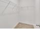 Empty walk-in closet with metal shelving and carpet flooring, offering ample storage space at 5175 Grand Canyon Rd, Concord, NC 28027