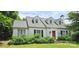 Charming home with dormer windows, red front door, and lush greenery in the front yard at 600 College Ave, Rock Hill, SC 29730